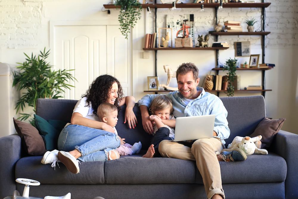 Young beautiful happy family relaxing at home